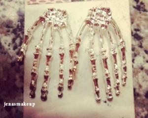 Skeleton Hand Earrings. Not sure but I think they are sterling silver. Asking price is $5